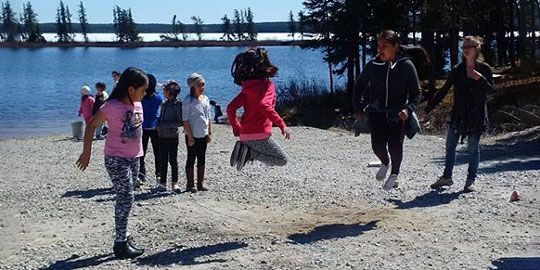 Children engaged in outdoor activities at a summer literacy camp